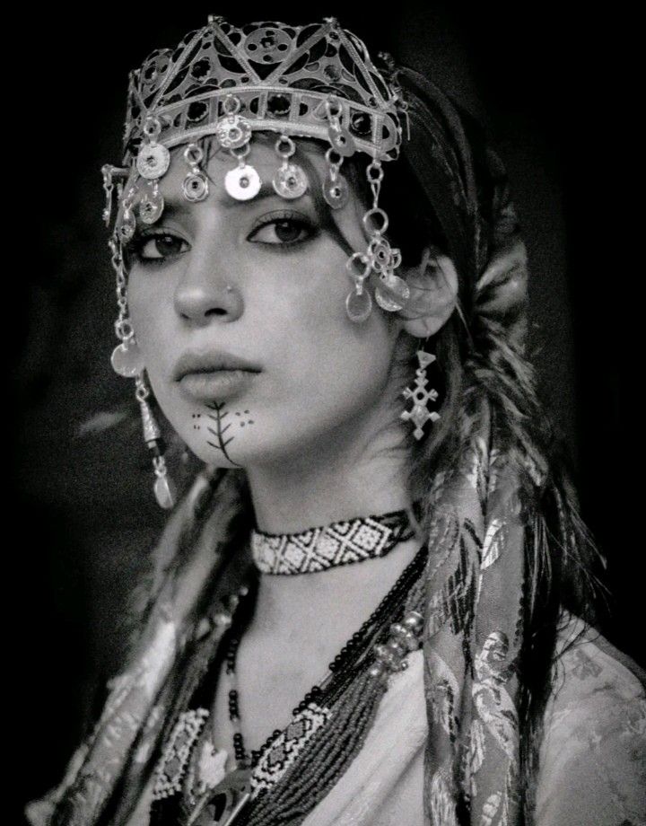 Black-and-white portrait of an Amazigh woman wearing traditional silver jewellery